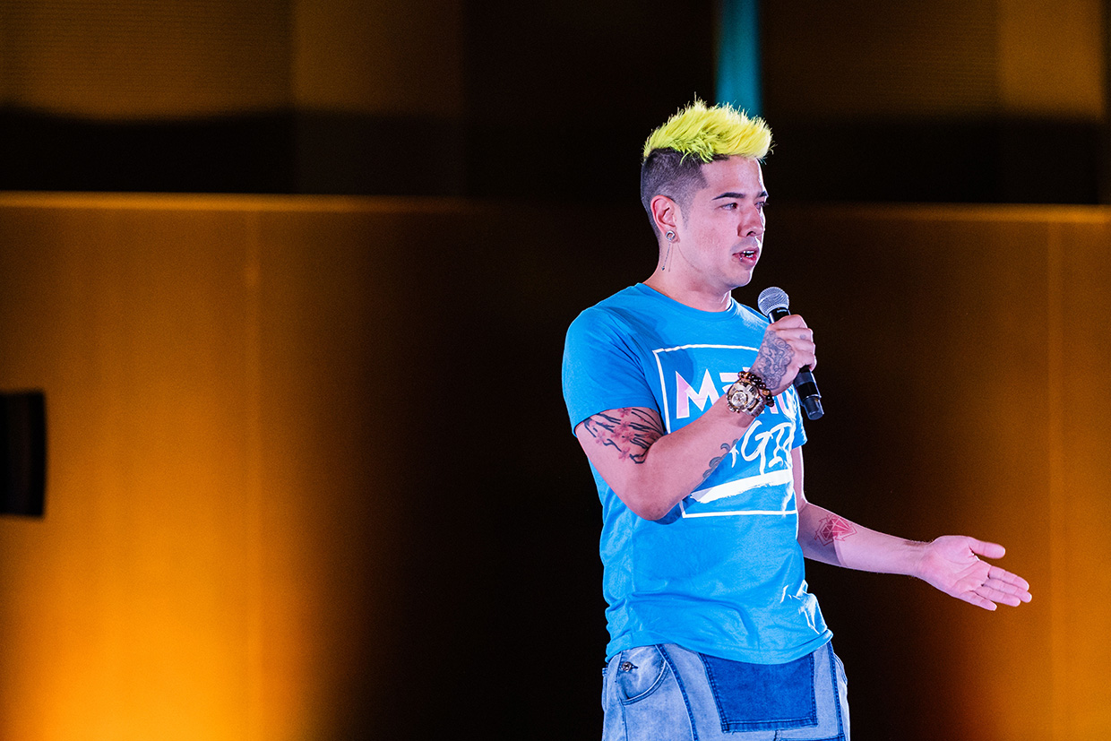 A young man speaks to Summit 2024 conventioneers.